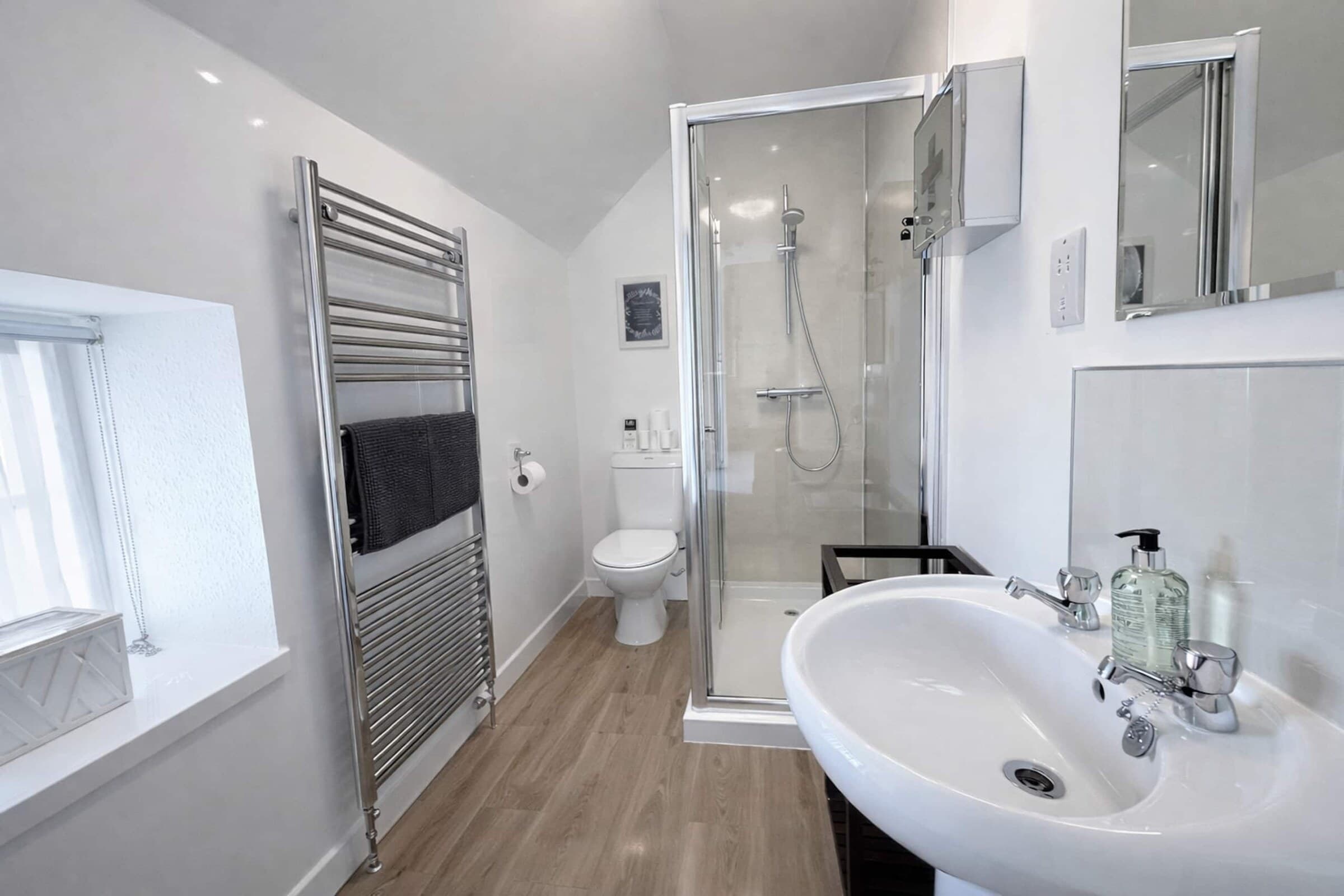 The modern shower room with a heated towel rail