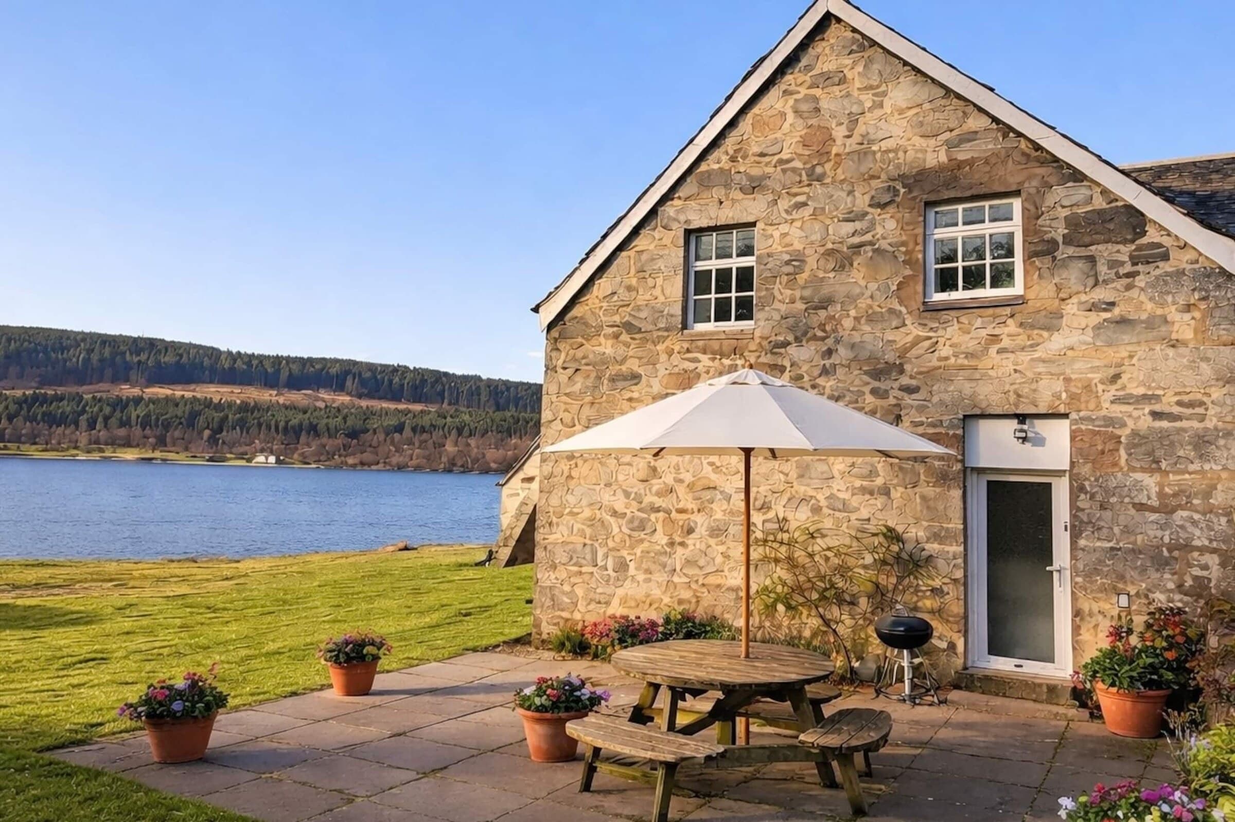 The Stable Loft — a 200-year-old stone steading, with Loch Tummel directly behind it